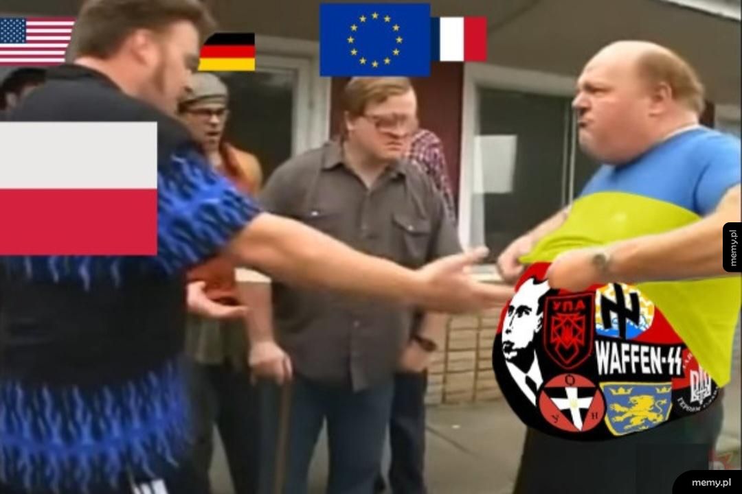 Mężczyźni w koszulach dyskutują, jeden z nich trzyma flagi różnych krajów.